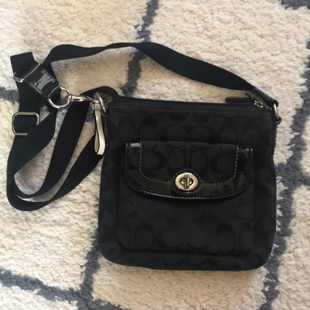 Black Coach crossbody purse with iconic C pattern